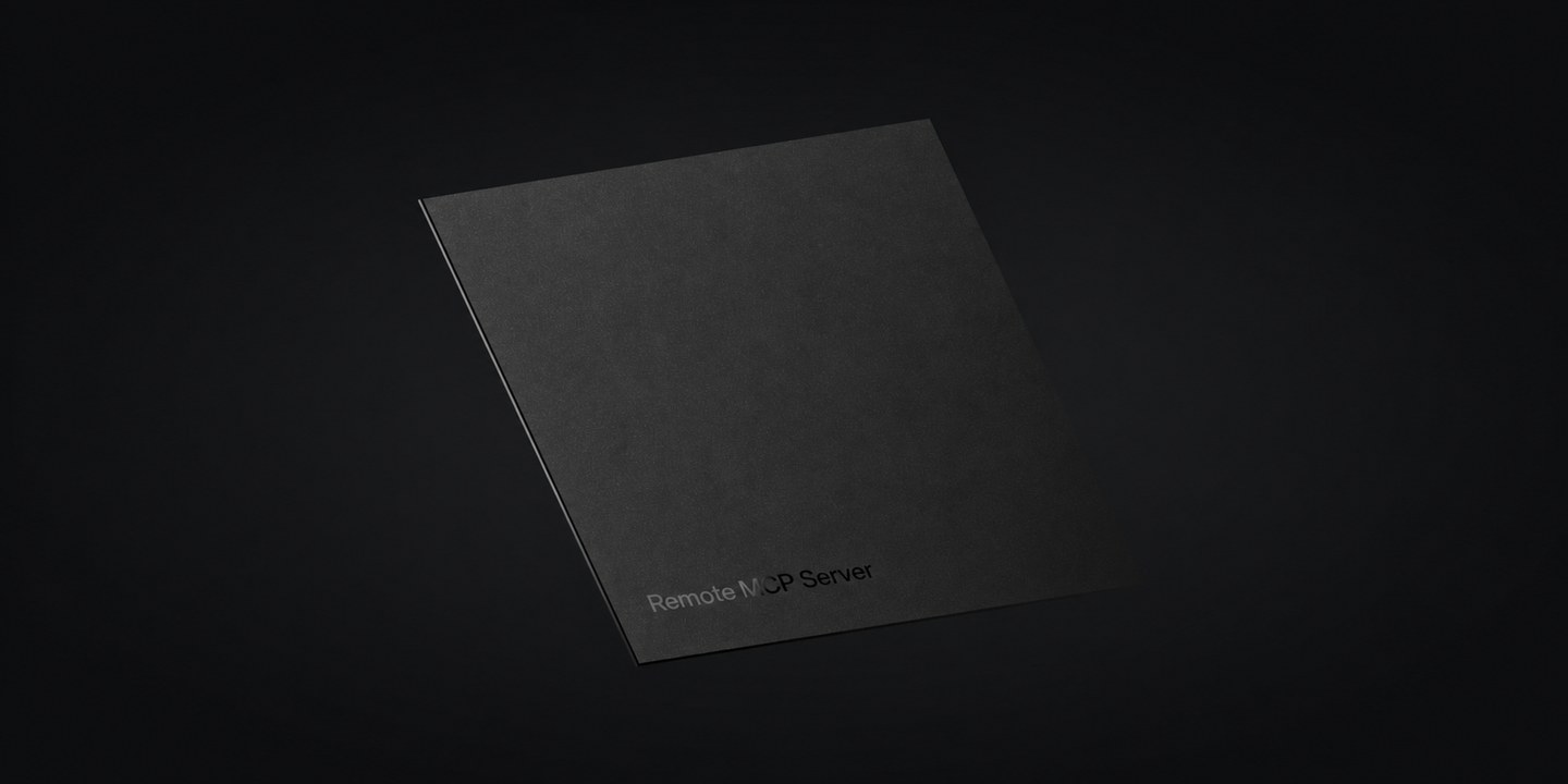 A matte black square plate photographed at an angle on a dark background, embossed with the words Remote MCP Server.